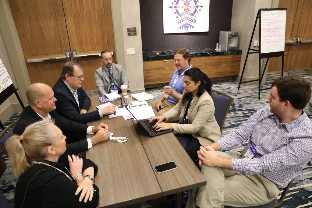 Members discuss around a table