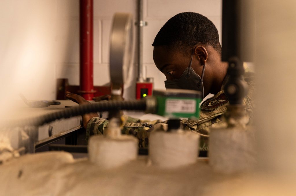 An airman works in a shop