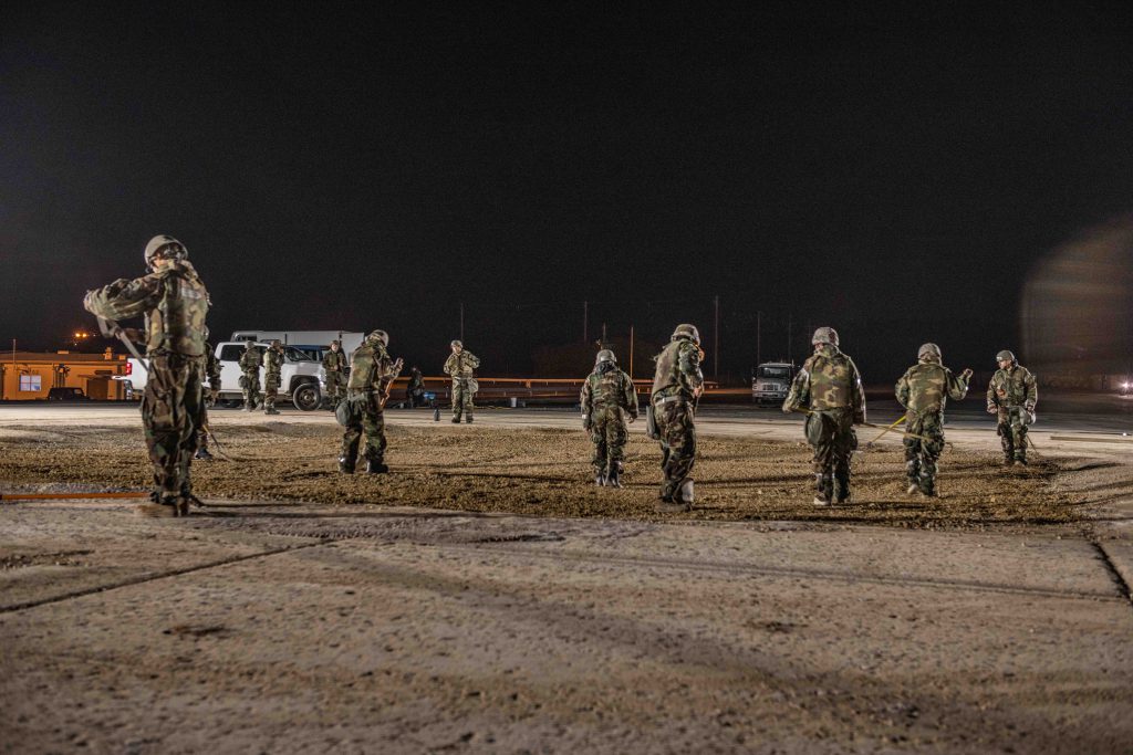 Engineers work on an airfield at night